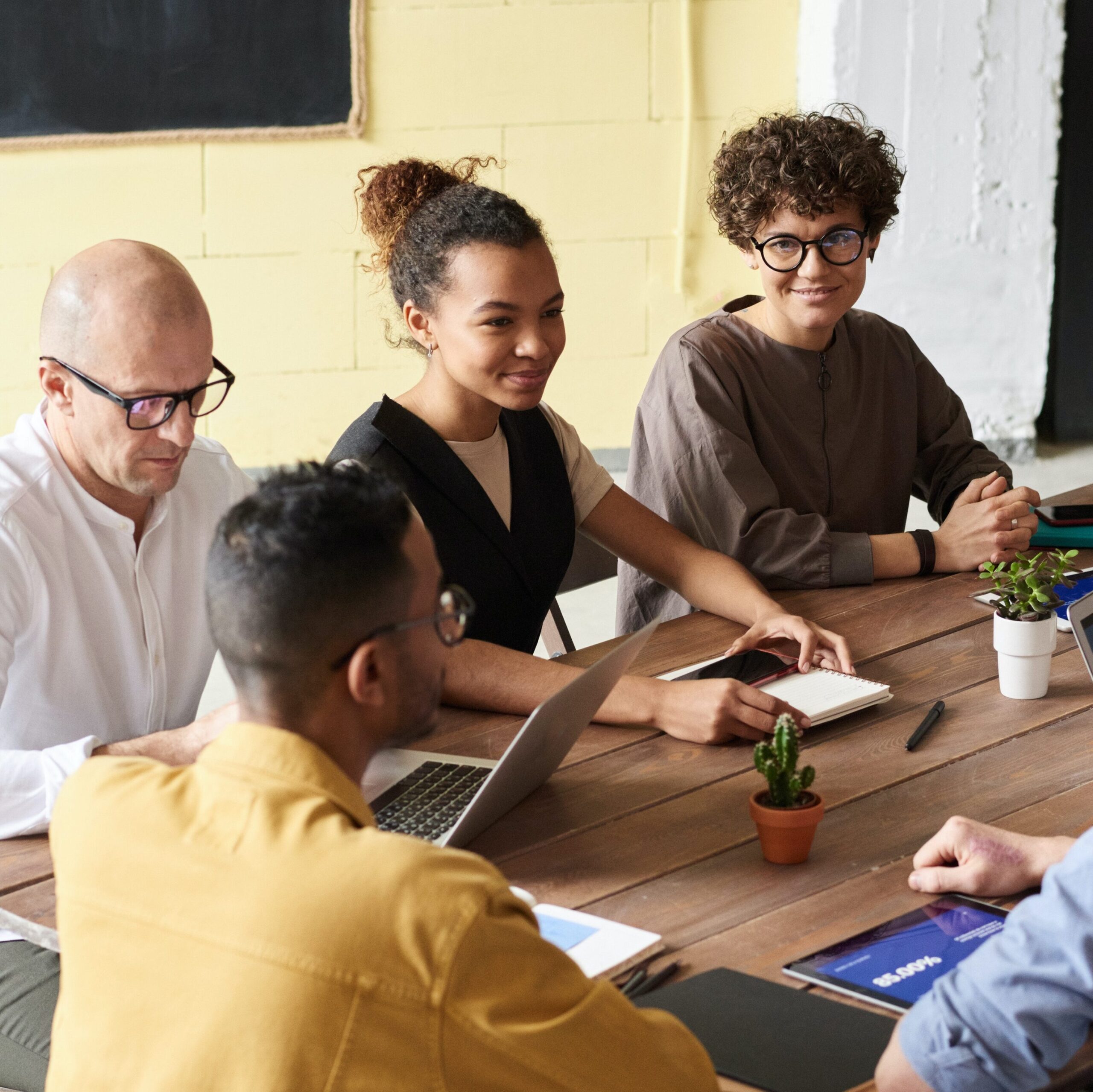 Photo of People Learning on  a Wood Table