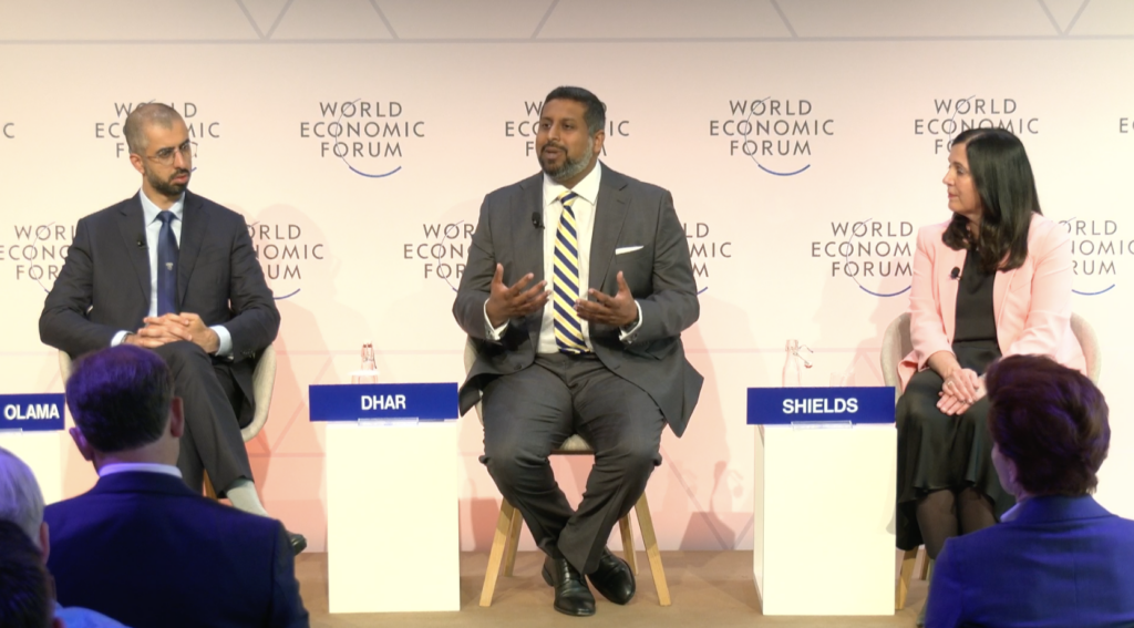 Vilas Dhar presents on panel on stage at Davos.