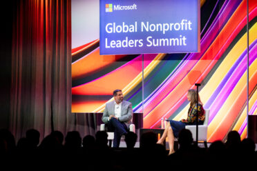 Vilas Dhar appears on stage with Kate Behncken at the 2024 Microsoft Global Nonprofit Leaders Summit